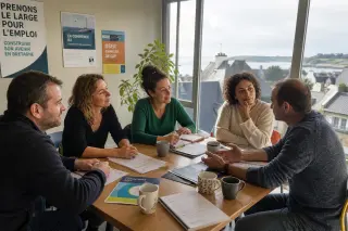 Adults of varied backgrounds in a rural Breton training center, discussing career options together around a table, natural light and subtle warmth emphasize a real, supportive atmosphere.